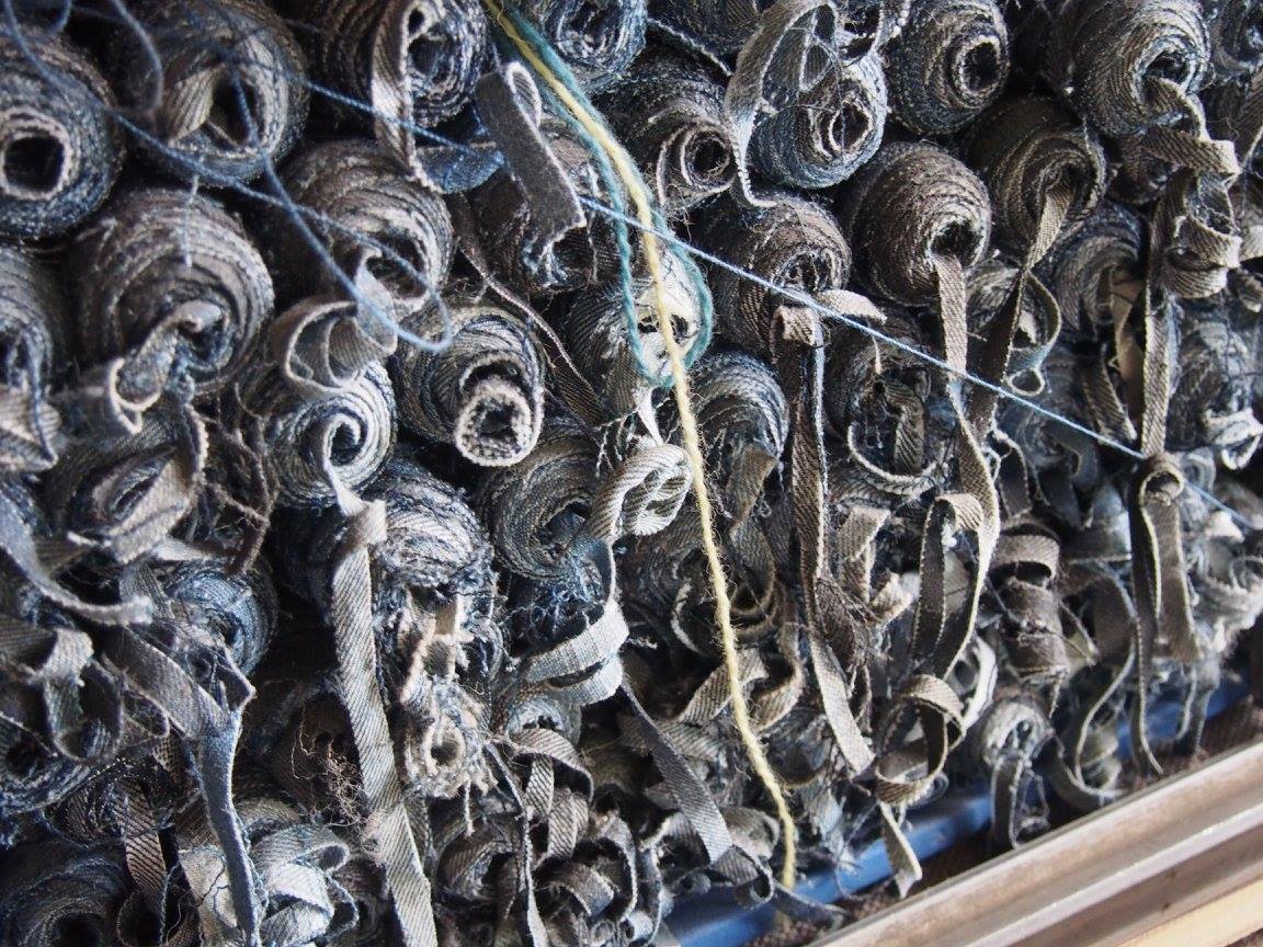 Jeans surplus textiles lined up in a factory in Poland.